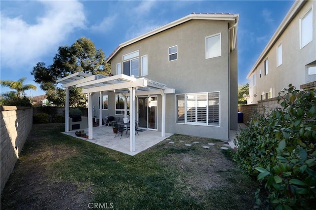 back of property featuring a yard, a patio area, and a pergola