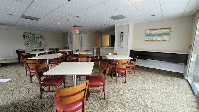 dining room featuring a drop ceiling