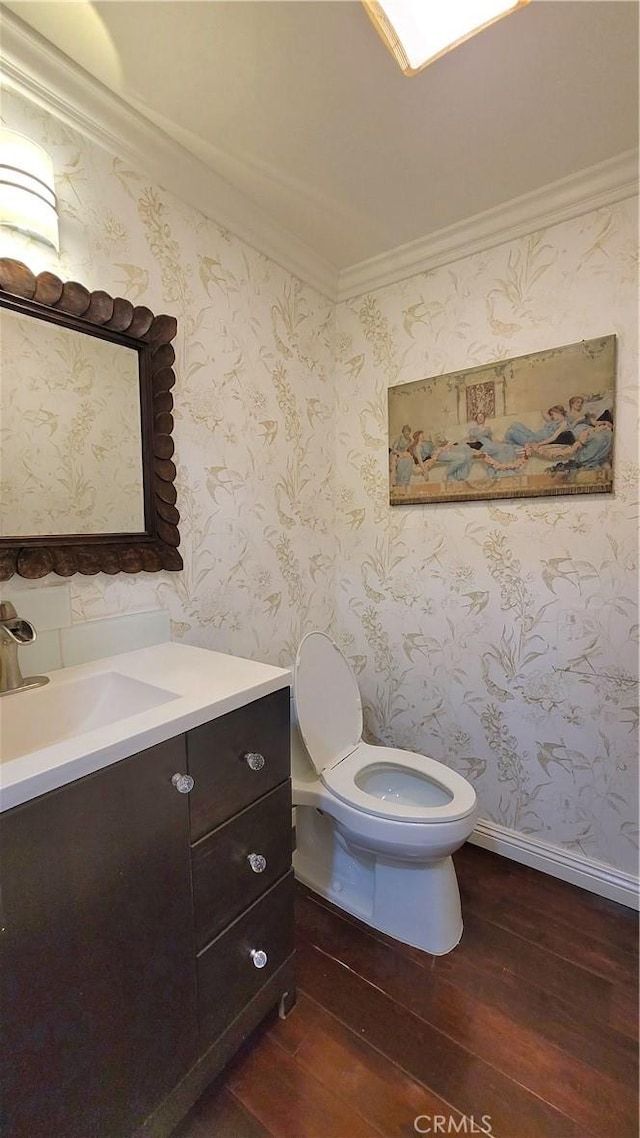 bathroom with vanity, hardwood / wood-style flooring, and toilet