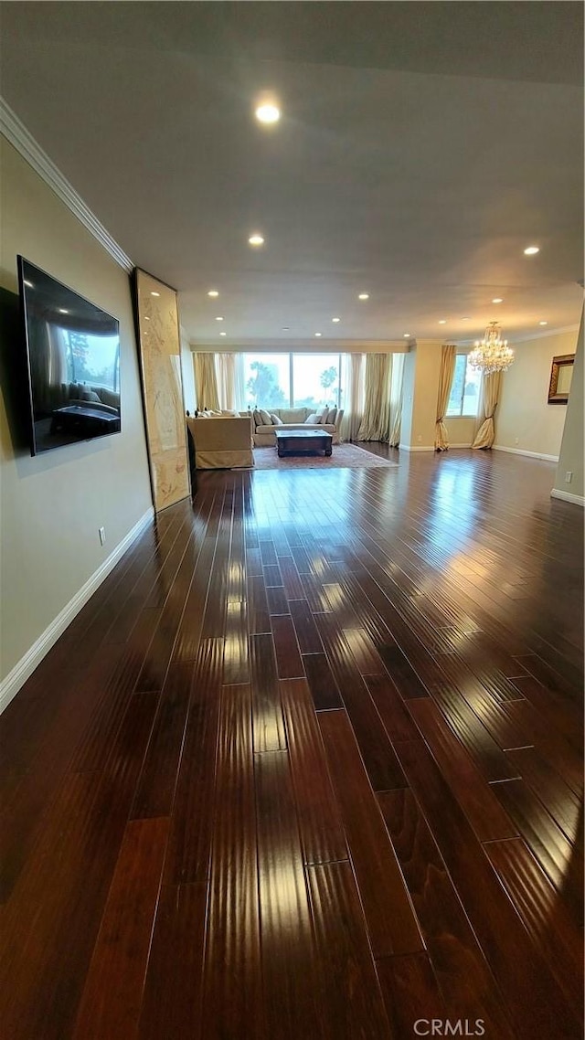 interior space featuring crown molding, dark hardwood / wood-style floors, and a chandelier