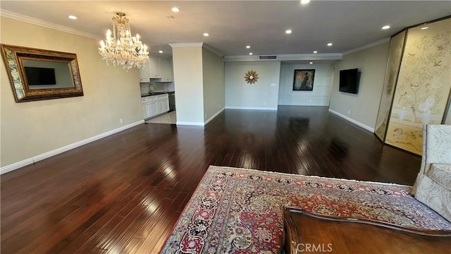 living room featuring ornamental molding, dark hardwood / wood-style flooring, a chandelier, and sink