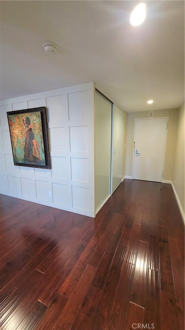 unfurnished room featuring dark hardwood / wood-style floors