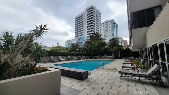 view of swimming pool with a patio area