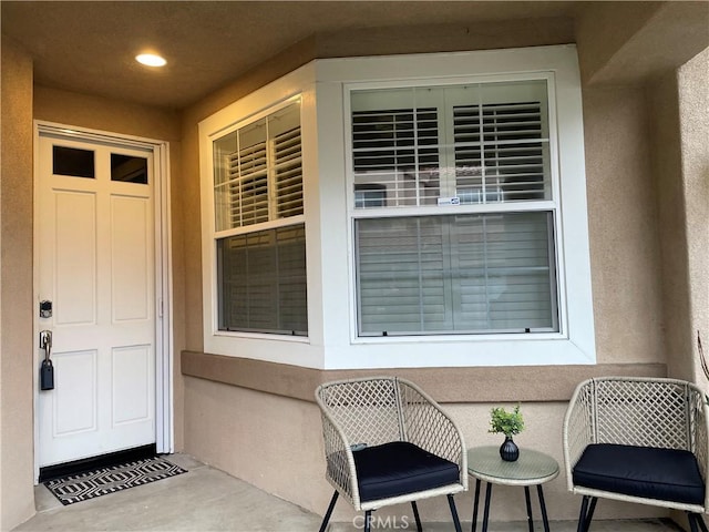 property entrance featuring stucco siding