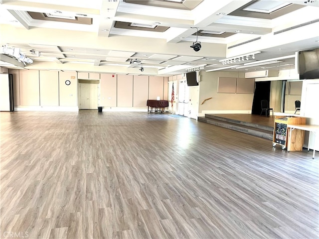 interior space featuring beam ceiling, coffered ceiling, and wood finished floors