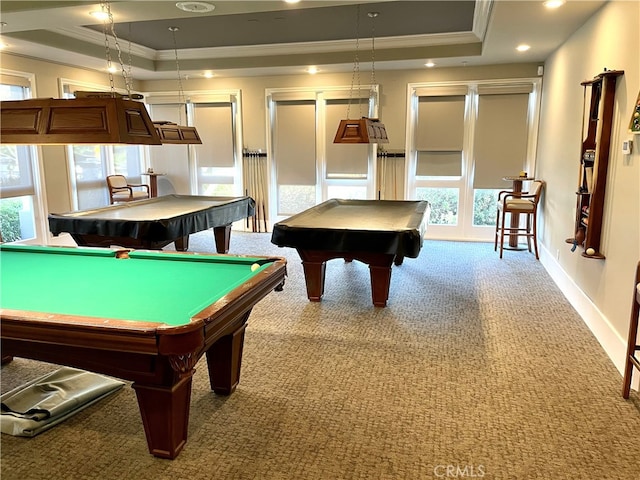 recreation room with ornamental molding, pool table, a tray ceiling, and light carpet