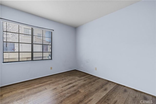 spare room with hardwood / wood-style flooring