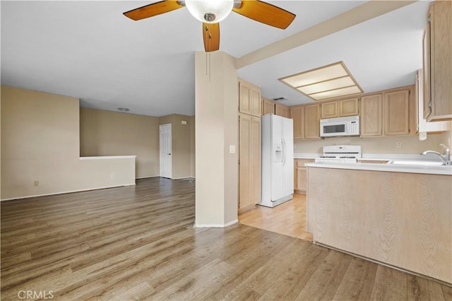 kitchen featuring white appliances, light brown cabinetry, and light hardwood / wood-style floors