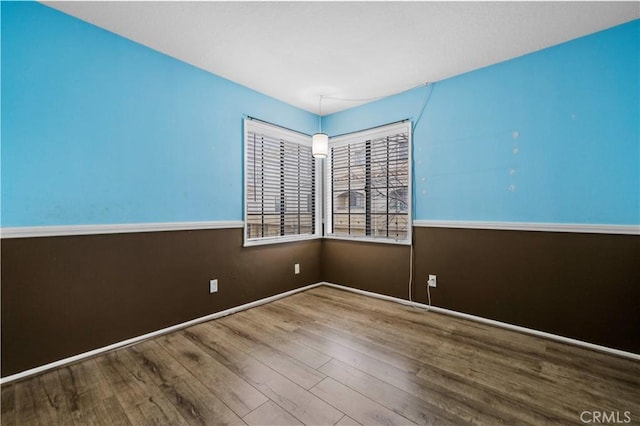 empty room with hardwood / wood-style floors