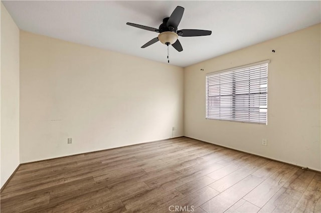 unfurnished room featuring hardwood / wood-style flooring and ceiling fan