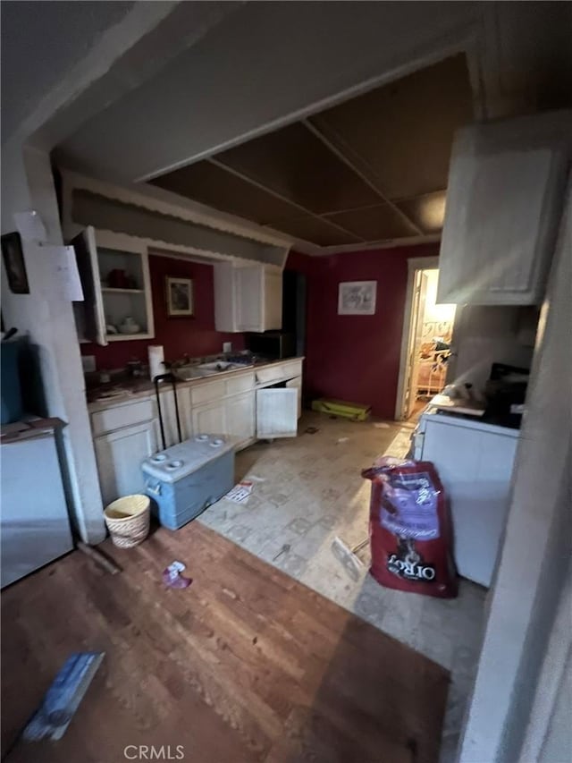 kitchen featuring white cabinetry and light wood-type flooring