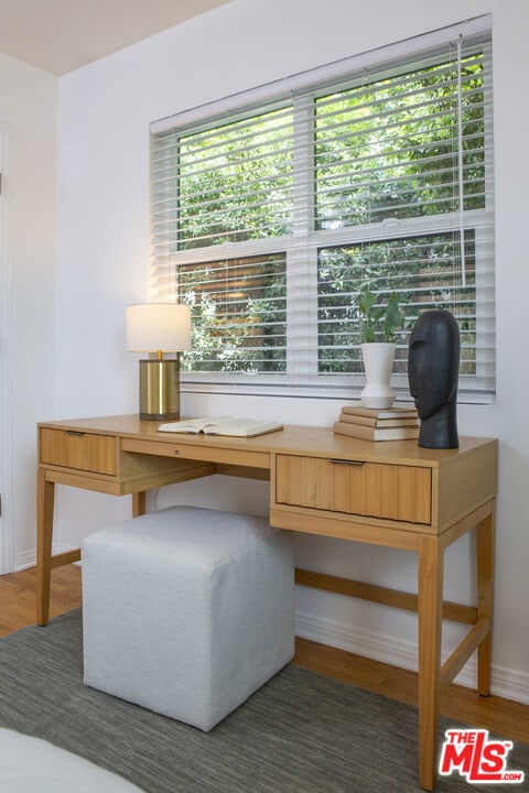 office area with built in desk and dark hardwood / wood-style floors