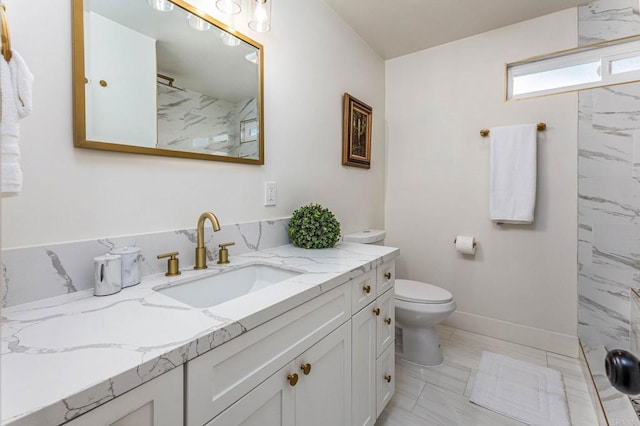 bathroom featuring vanity, toilet, and a shower