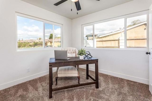 carpeted home office featuring ceiling fan