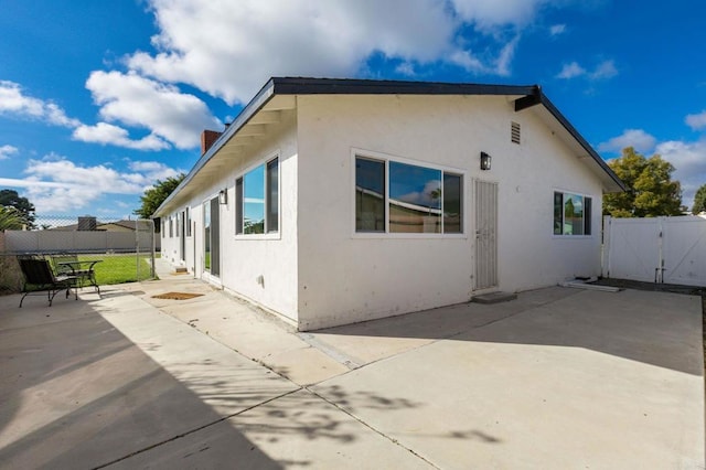 view of property exterior featuring a patio area