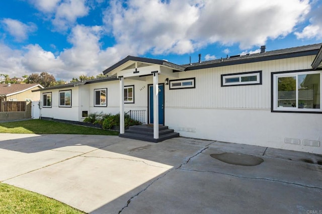 ranch-style home with a patio and a front lawn