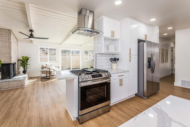 kitchen featuring light stone countertops, white cabinetry, appliances with stainless steel finishes, and range hood