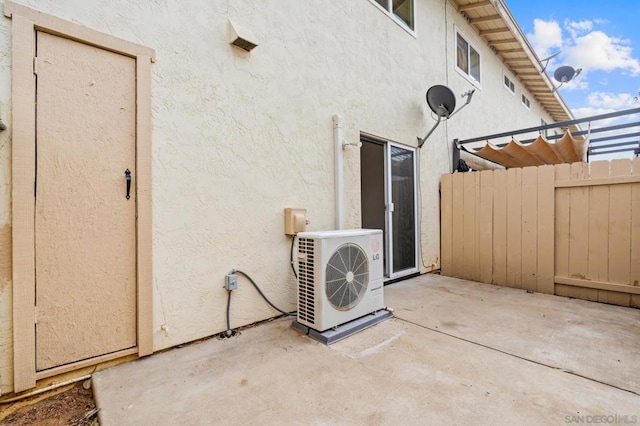 view of property exterior featuring a patio and ac unit