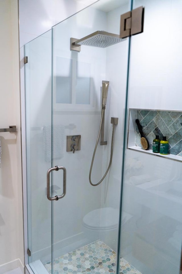 bathroom with toilet, decorative backsplash, and walk in shower