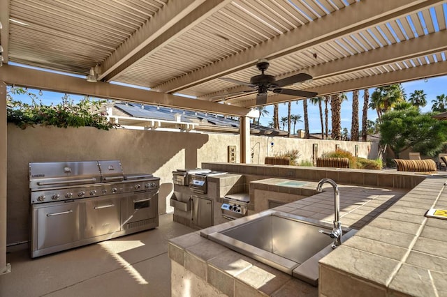 view of patio with an outdoor kitchen, a grill, and a pergola