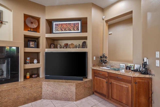 bathroom with built in shelves, tile patterned floors, and vanity