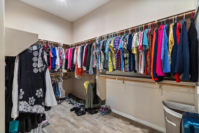 walk in closet with hardwood / wood-style flooring