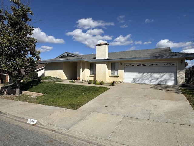 view of front of property featuring a garage and a front lawn