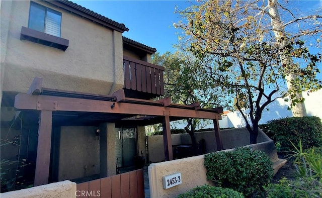 view of side of home with a balcony