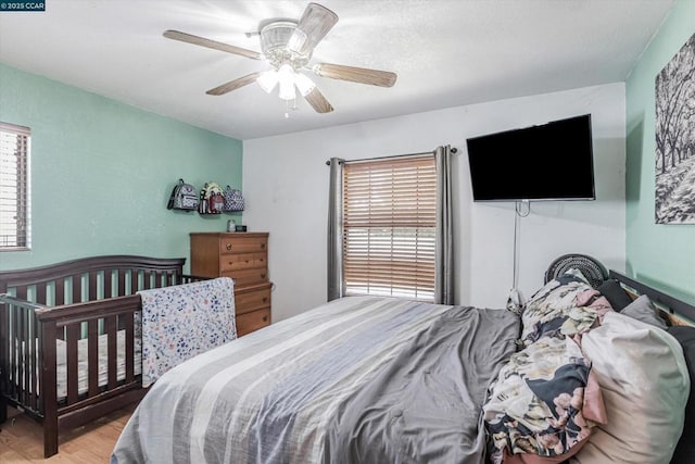 bedroom with ceiling fan and light hardwood / wood-style floors