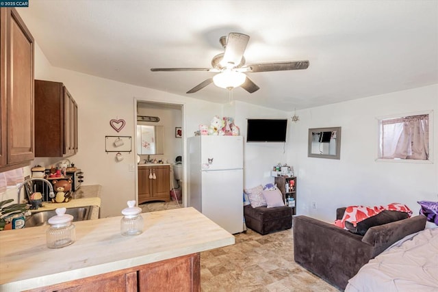 interior space with sink, ceiling fan, and white refrigerator