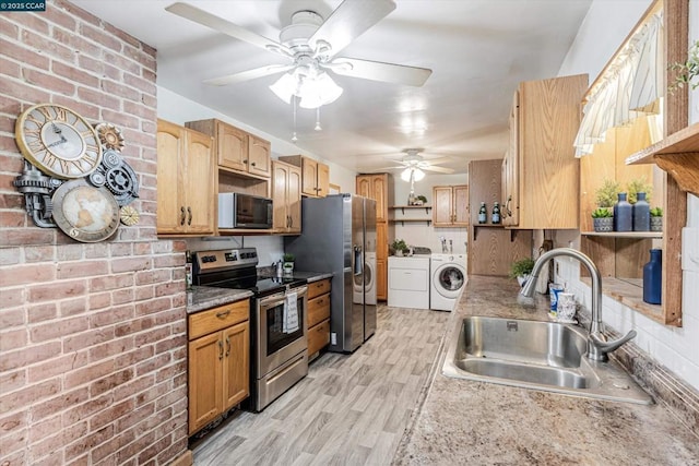 kitchen with sink, light hardwood / wood-style flooring, washer and clothes dryer, ceiling fan, and stainless steel appliances