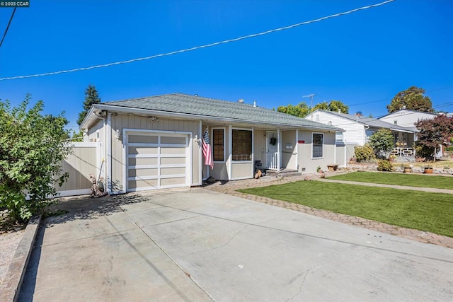 ranch-style house featuring a garage and a front lawn