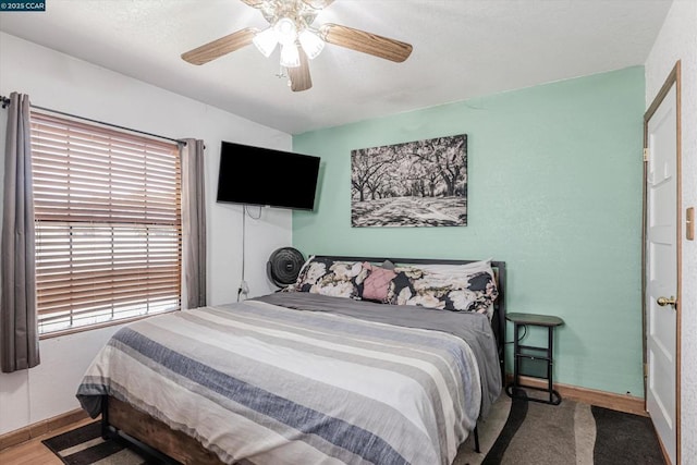 bedroom with wood-type flooring and ceiling fan