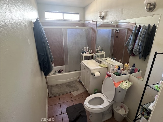 full bathroom with toilet, tile patterned floors, shower / bath combination with glass door, and vanity