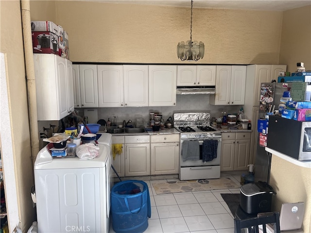 kitchen featuring light tile patterned floors, sink, white cabinetry, washer / clothes dryer, and white gas stove