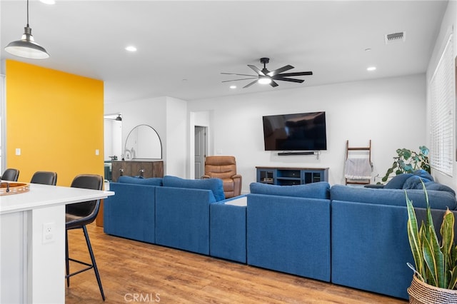 living room with ceiling fan and light wood-type flooring