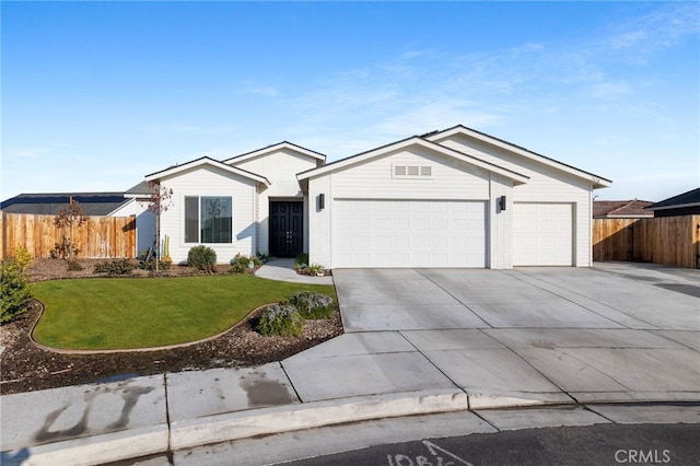 ranch-style home featuring a garage and a front yard