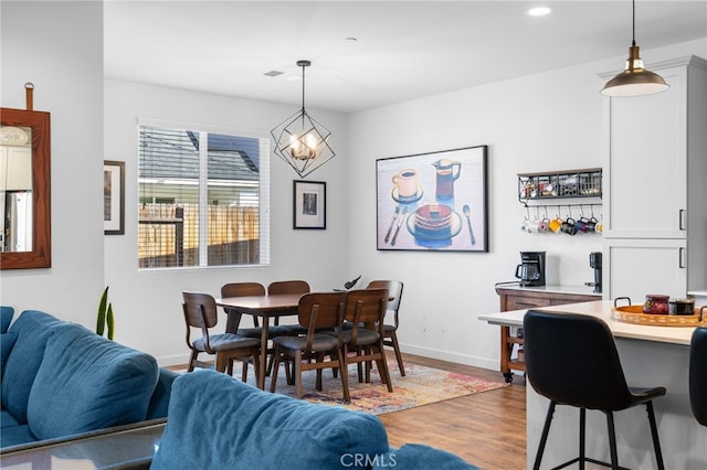 dining area with a chandelier and light wood-type flooring