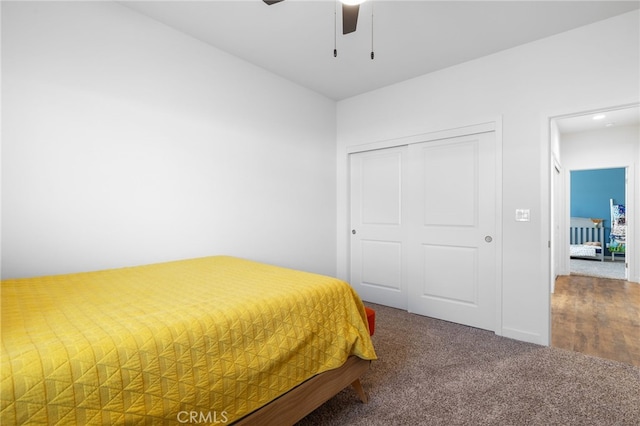 unfurnished bedroom with ceiling fan, a closet, and carpet