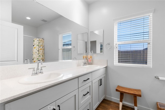 bathroom featuring vanity, curtained shower, and hardwood / wood-style flooring