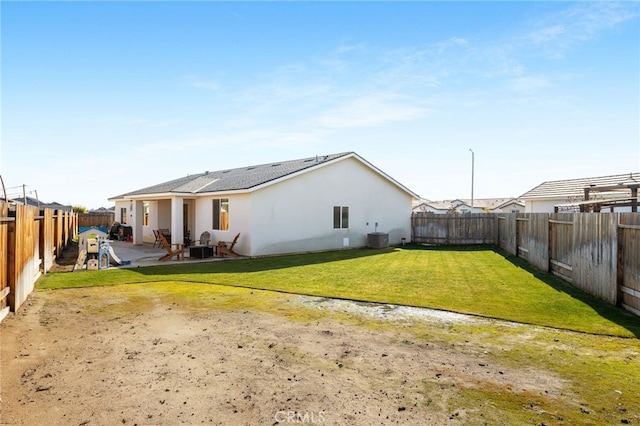 back of house featuring a yard, a patio, and central air condition unit