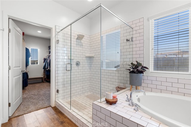 bathroom featuring wood-type flooring and plus walk in shower