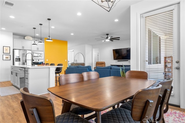 dining area featuring ceiling fan and light hardwood / wood-style floors