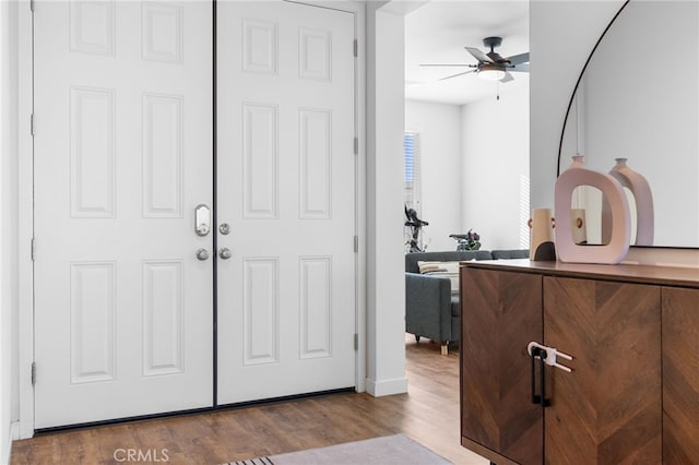 foyer featuring wood-type flooring and ceiling fan