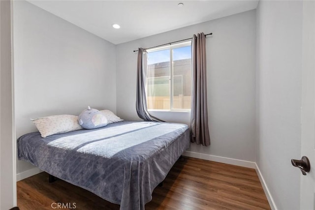 bedroom featuring dark hardwood / wood-style flooring