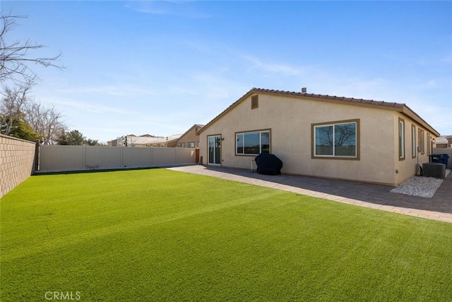 back of house featuring a patio and a lawn