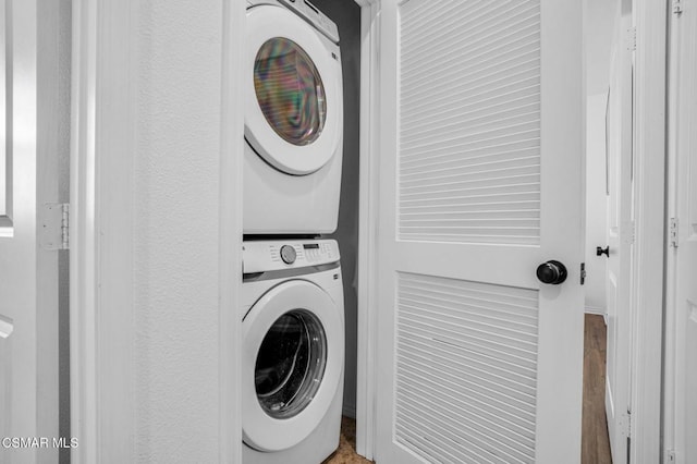 laundry area with stacked washing maching and dryer