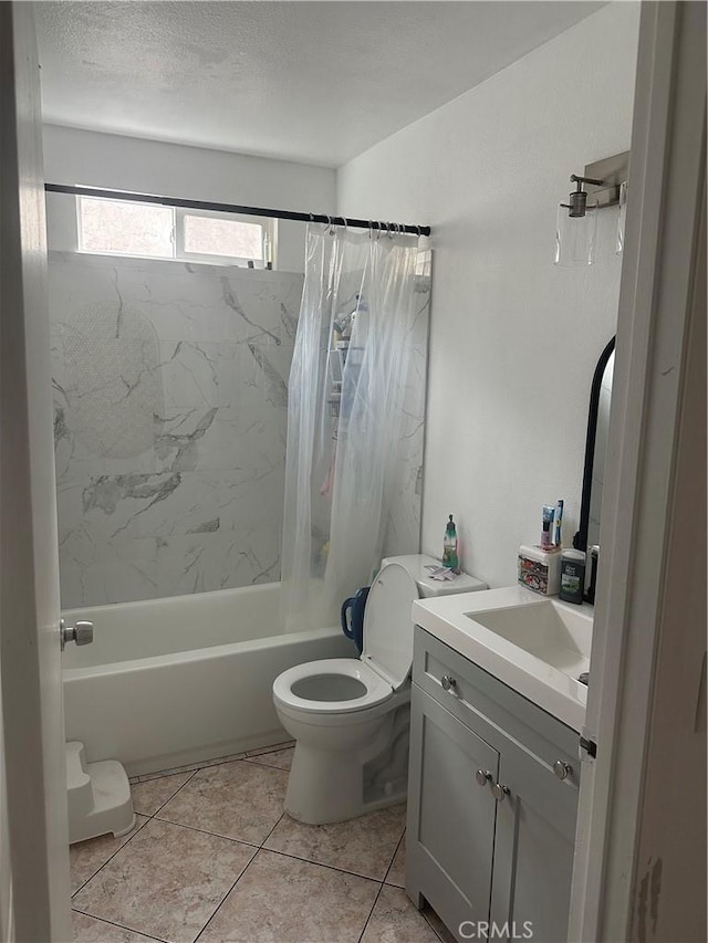 full bathroom with vanity, shower / tub combo, toilet, tile patterned floors, and a textured ceiling