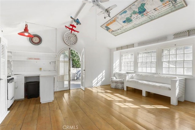 interior space with ceiling fan, plenty of natural light, sink, and light hardwood / wood-style floors