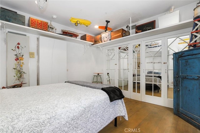 bedroom featuring dark wood-type flooring and french doors